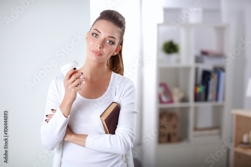 Attractive young businesswoman standing  near wall in office © lenets_tan