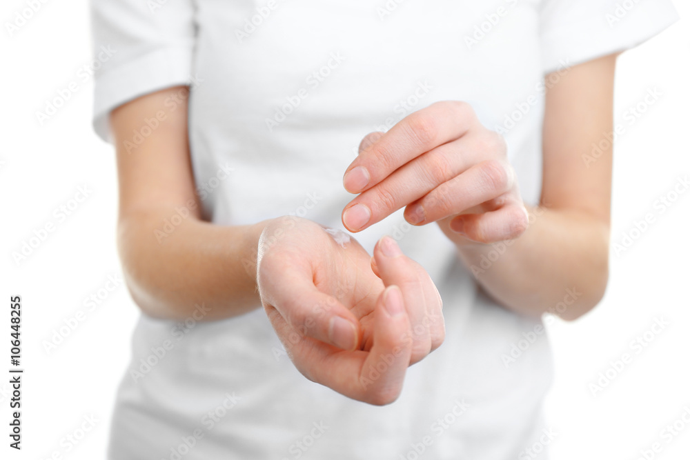 Woman applying hand cream, isolated on white Woman applying hand cream, isolated on white