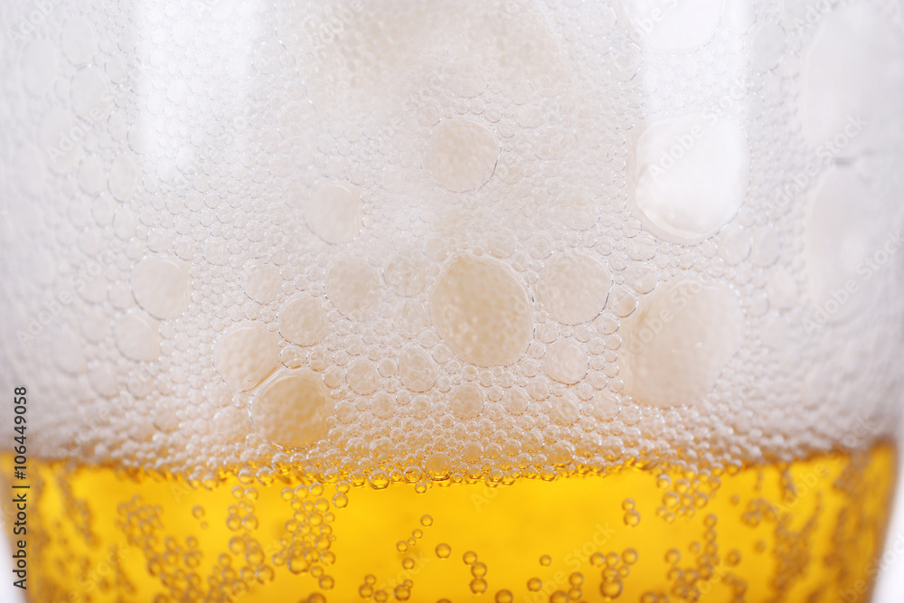 Glass of light beer with froth and bubbles, close up Glass of light beer with froth and bubbles, close up