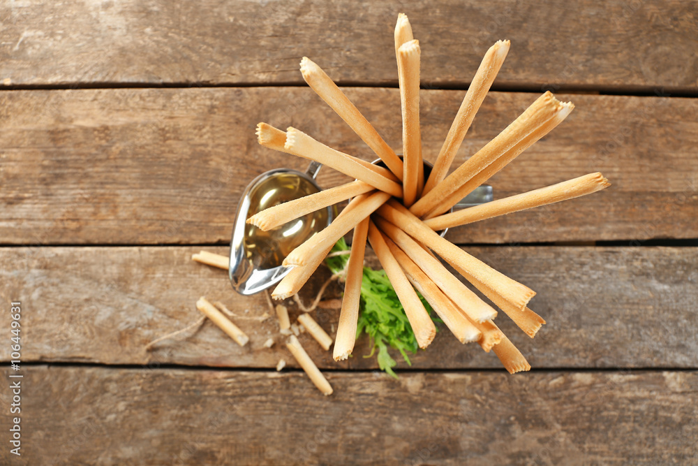 Bread sticks with arugula and oil, closeup Bread sticks with arugula and oil, closeup