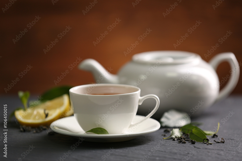 Cup of tea and teapot on table Cup of tea and teapot on table