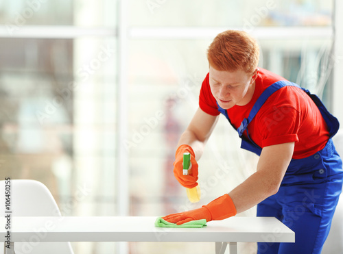 Young janitor with liquid d...