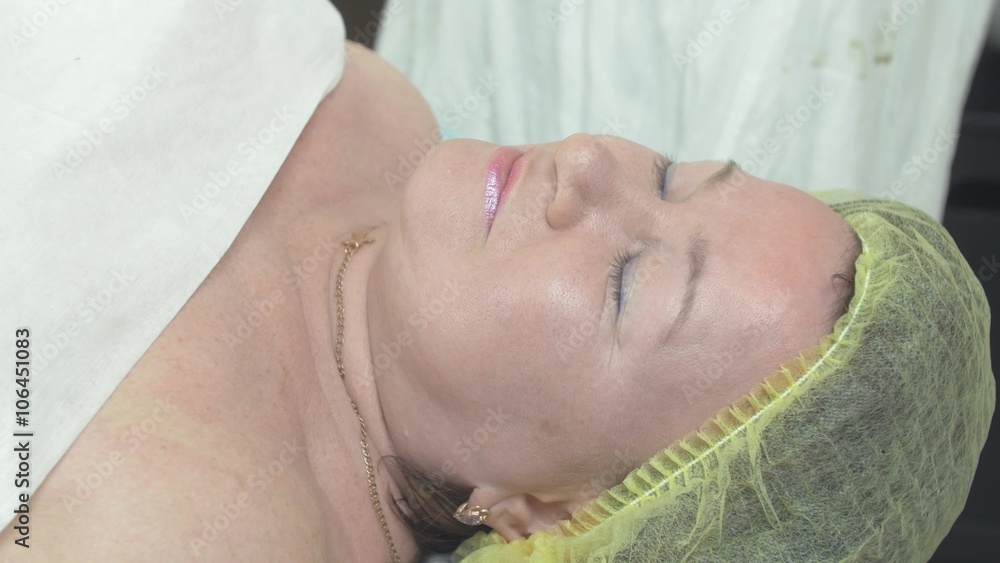 Close up of face adult thick woman lie in beauty saloon on procedures. Make up. Smile. Healthcare. Close up of face adult thick woman lie in beauty saloon on procedures. Make up. Smile. Healthcare.