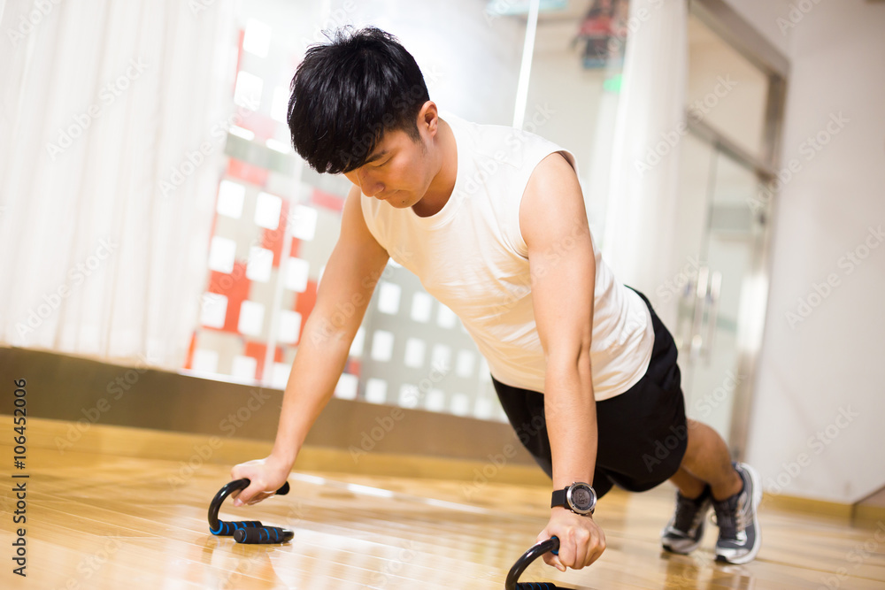 young handsome asian man works out in modern gym young handsome asian man works out in modern gym
