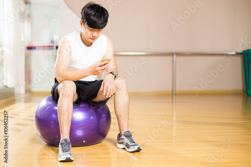 young handsome asian man works out in modern gym