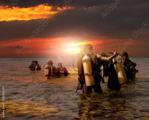 group of scuba diving preparing to night diving at sea side agai