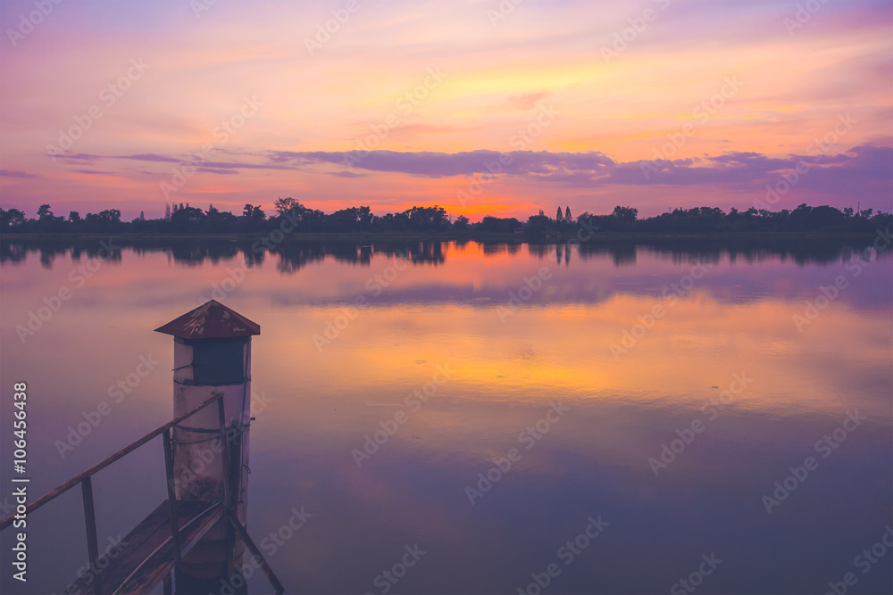 Beautiful sunset at the river, colorful clouds and water with reflection Beautiful sunset at the river, colorful clouds and water with reflection