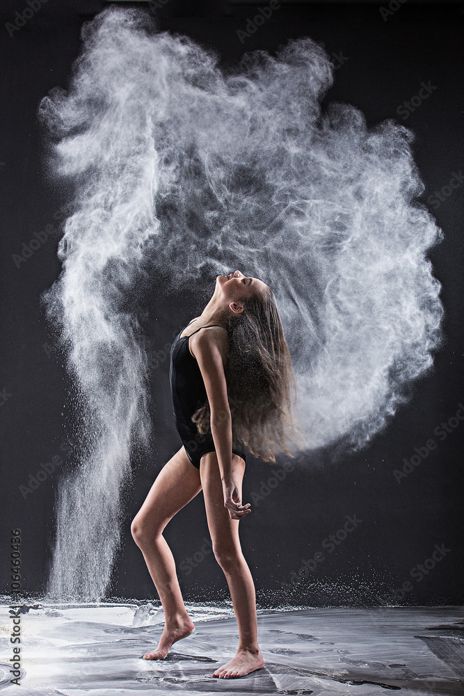 Dramatic portrait of strong teenage dancer with white powder exp