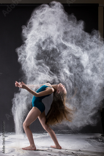 Young dancer in exploding white powder