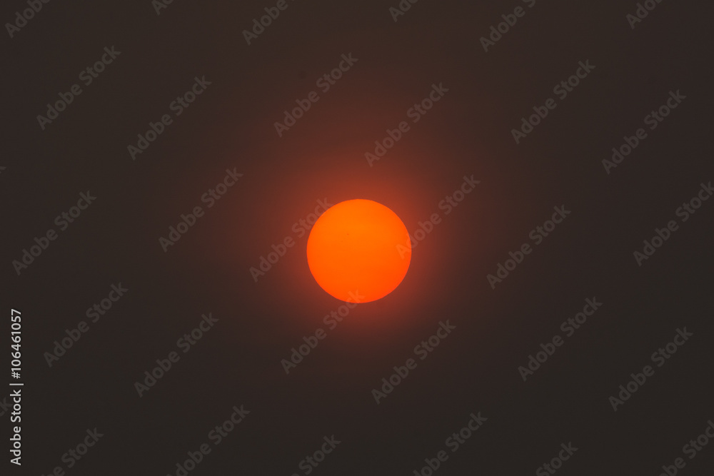 Red sun in the center of the image. 