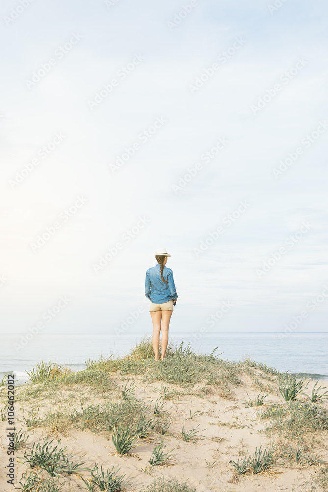 Woman walking away on the idylic beach.