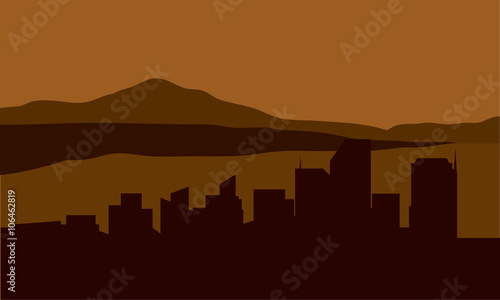 Silhouette of city with mountain background
