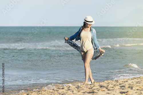 Woman walking away on the idylic beach.