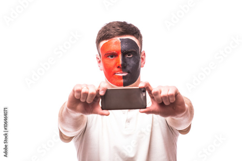 Albanian football fan take selfie photo with phone on whitebackground. European 2016 football fans concept. photo