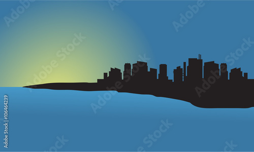 Silhouette of city at sunset in the beach