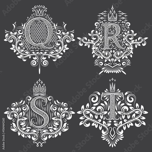 Set of heraldic monograms in coats of arms form. White floral decorative stamps on black. Isolated tattoo labels in vintage baroque style.