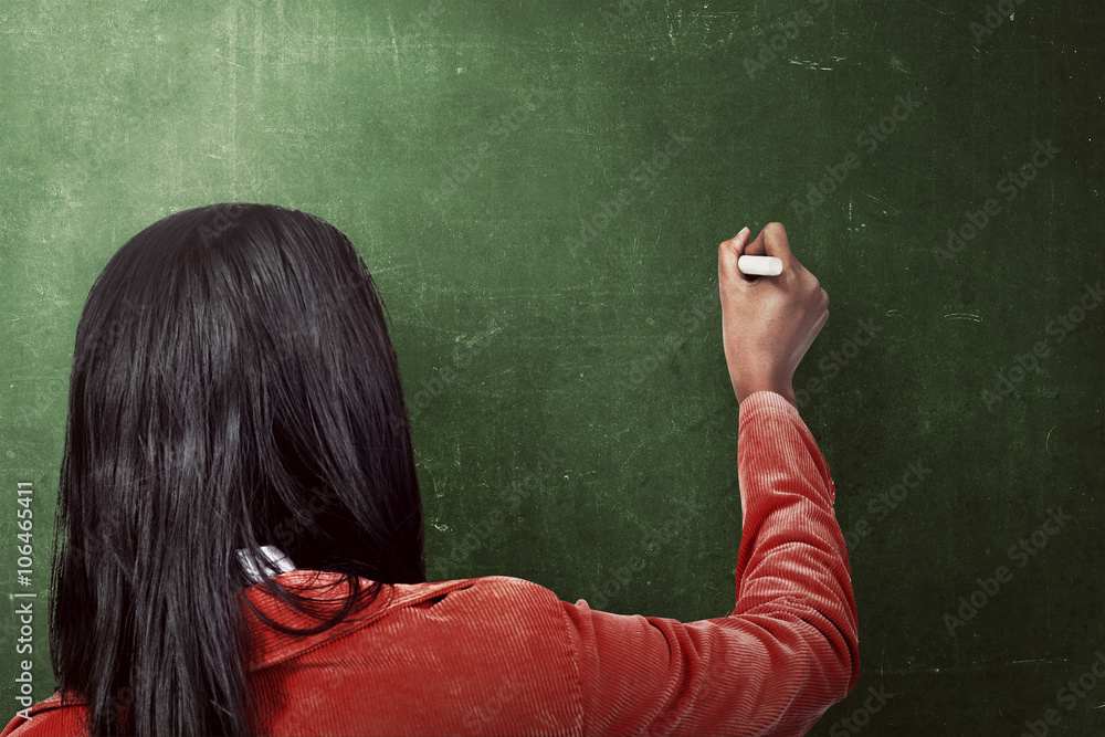 Asian woman drawing something on the blackboard