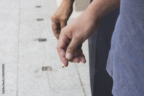 Hand Holding Cigarette While Smoking