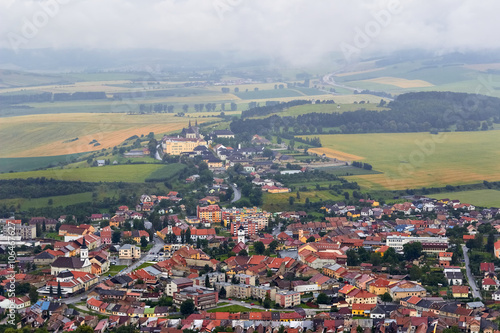 Little european willage, houses in fields, cloudy sky, mountains landscape