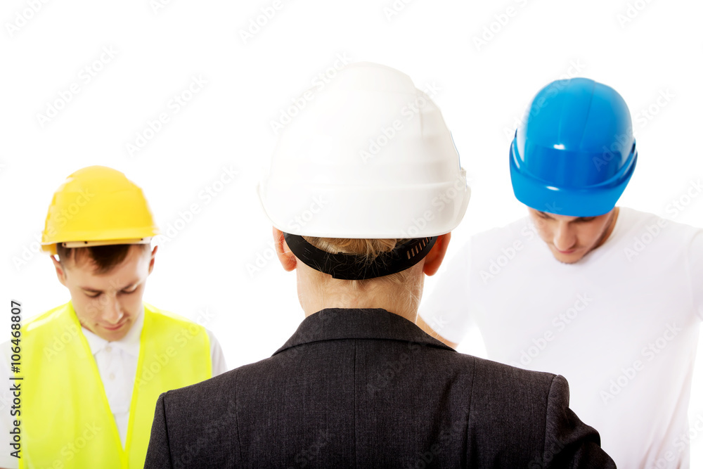 Female engineer talking with two builders Female engineer talking with two builders