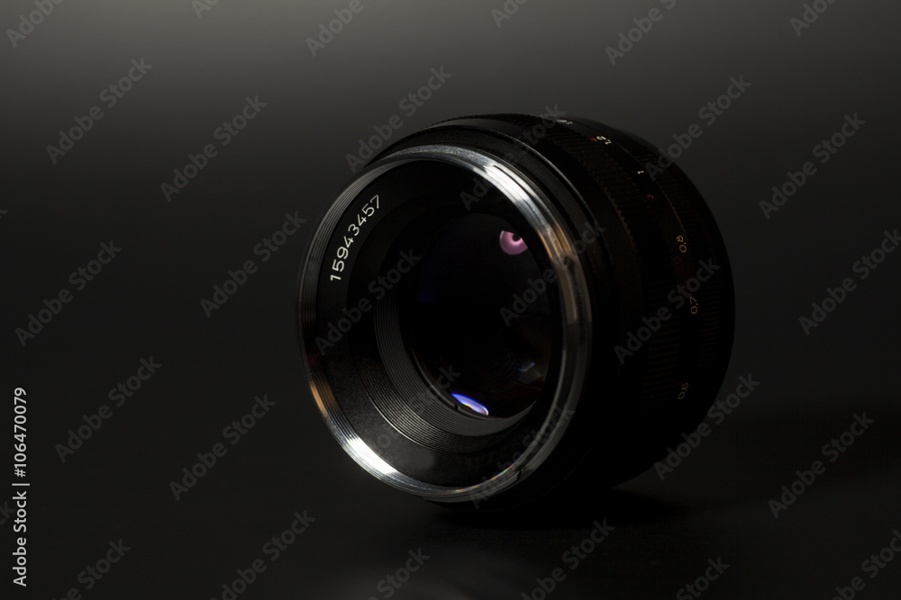 Camera photo lens over black background