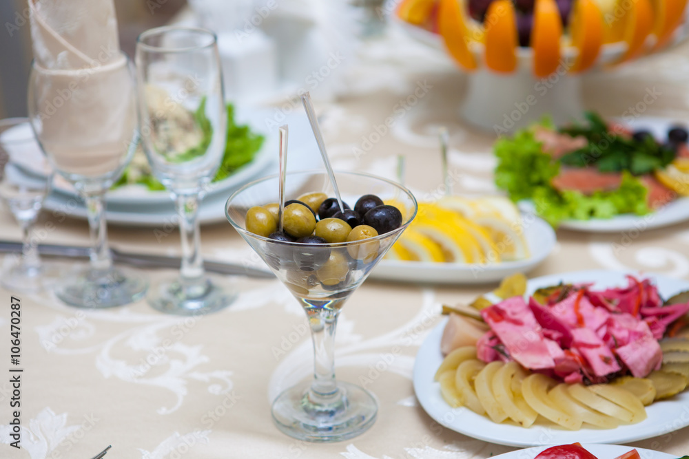 olives in a glass. Served banquet table