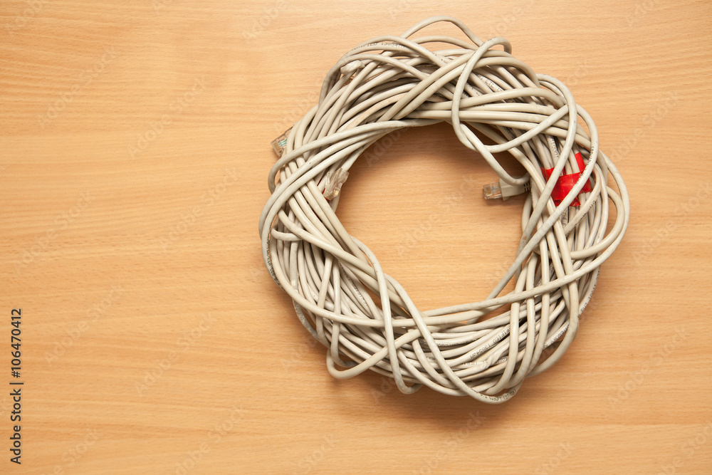 Cable Bay on a wooden background. Twisted pair, hank. Cable Bay on a wooden background. Twisted pair, hank.