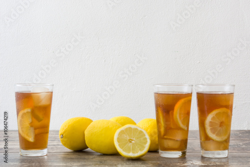 refreshing iced tea with lemon on wood