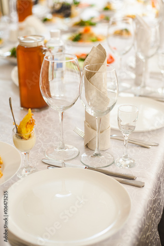 Table served with different food and flatware. Beautiful table ready for guests. Vertical color image. © Andrii Oleksiienko