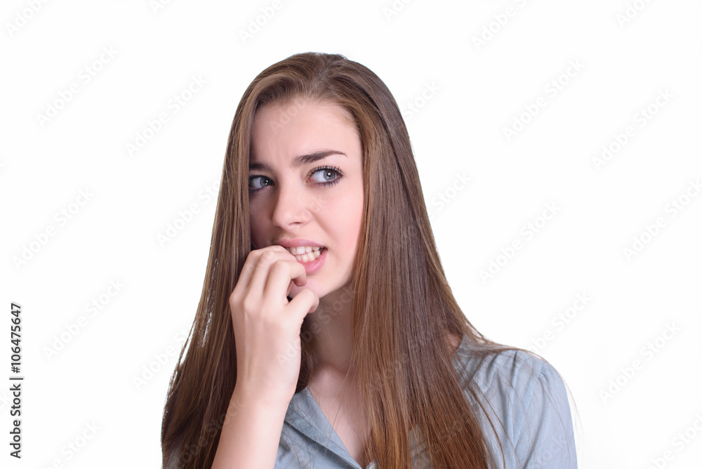 Nervous young woman biting her nails Nervous young woman biting her nails
