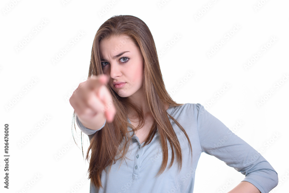 Angry young woman pointing at camera with her finger Angry young woman pointing at camera with her finger