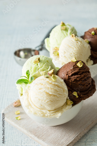 Colorful ive cream scoops in white bowl