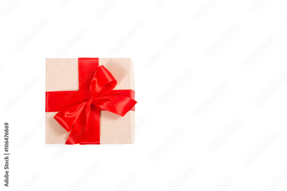 Gift box wrapped in recycled paper with red ribbon Gift box wrapped in recycled paper with red ribbon