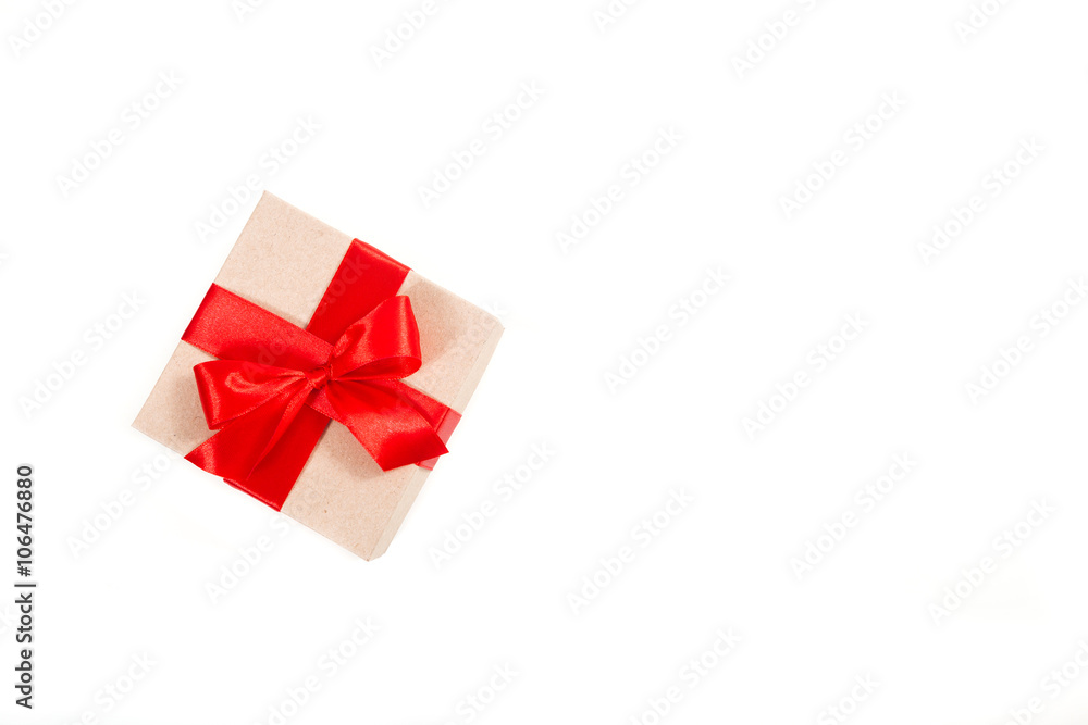Gift box wrapped in recycled paper with red ribbon Gift box wrapped in recycled paper with red ribbon