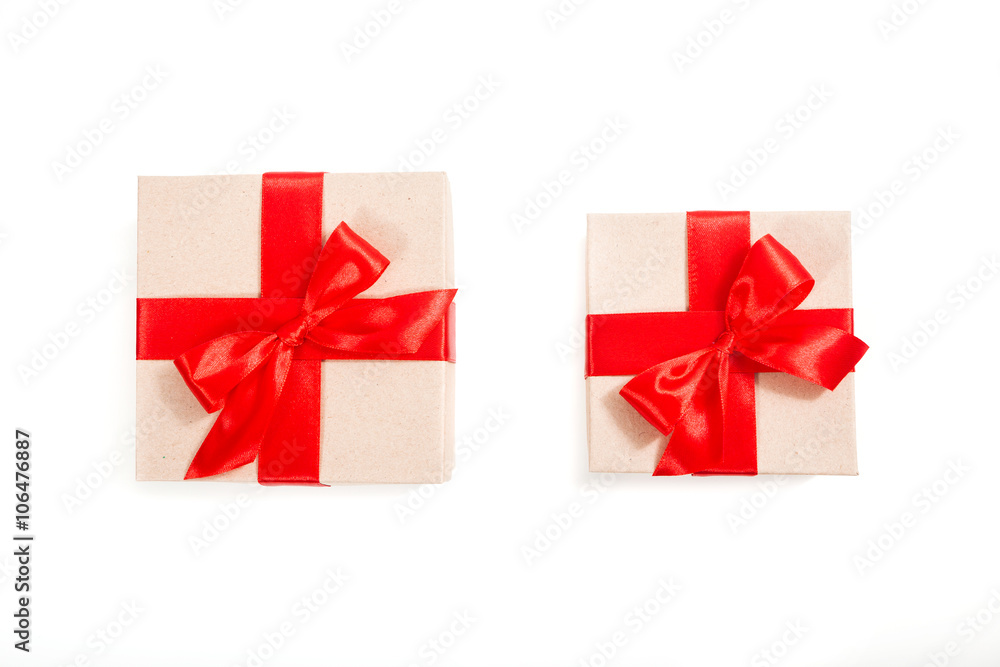 Gift box wrapped in recycled paper with red ribbon Gift box wrapped in recycled paper with red ribbon