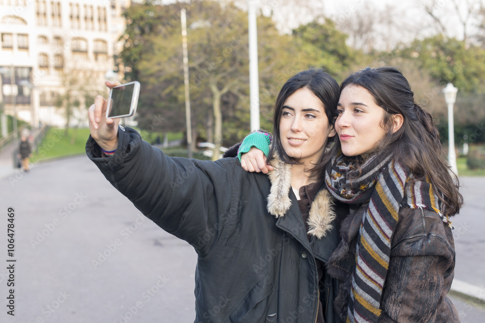 Two woman friends making selfie.