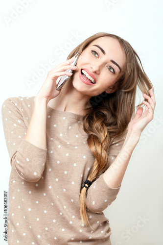 Happy woman phone talking. Face with toothy smile. Beauty stylish blonde woman with pink lips and perfect makeup posing in studio over white background. Beauty Woman Open Mouth.