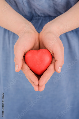 woman hands holds red heart