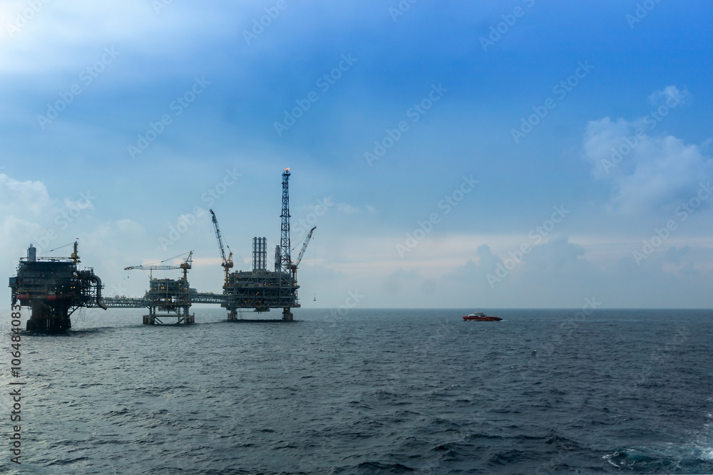 A small boat approaching oil rig at oilfield