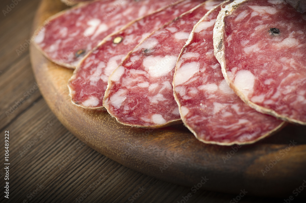 wooden cutting board with salami and bread wooden cutting board with salami and bread