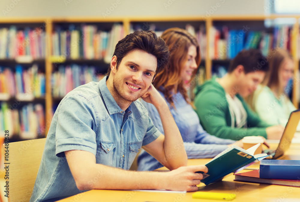 happy student boy reading book in library happy student boy reading book in library