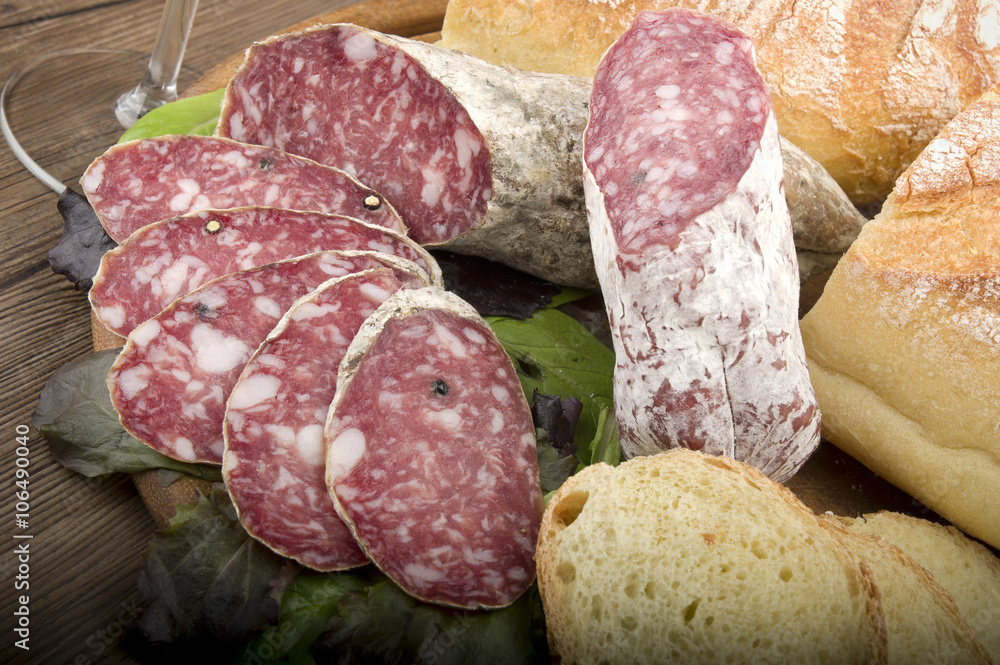 wooden cutting board with salami and bread wooden cutting board with salami and bread
