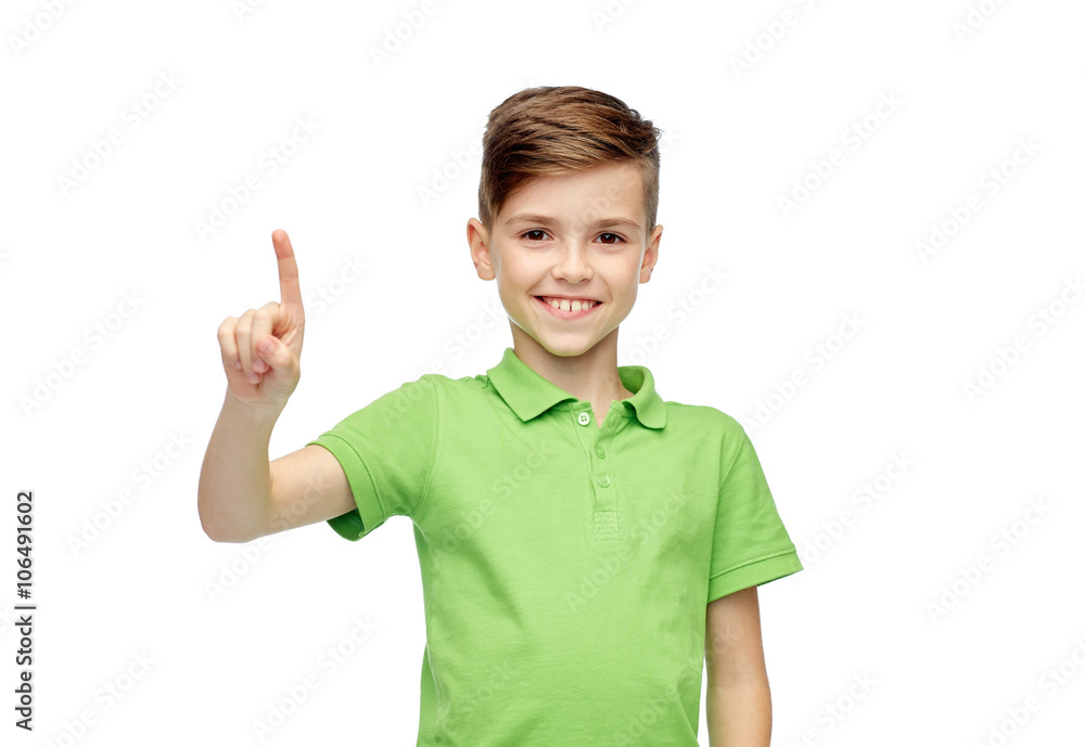 happy boy in green polo t-shirt pointing finger up happy boy in green polo t-shirt pointing finger up