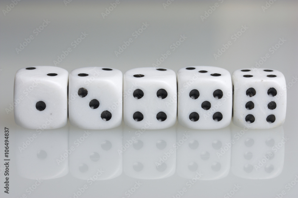 Dice. Playing cubes. Throwing the dice during the game. White cubes arranged in a row. On a white background. There is room for text. Dice. Playing cubes. Throwing the dice during the game. White cubes arranged in a row. On a white background. There is room for text.
