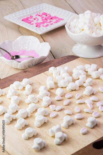 Cut marshmallows for easter bunny cake decoration.