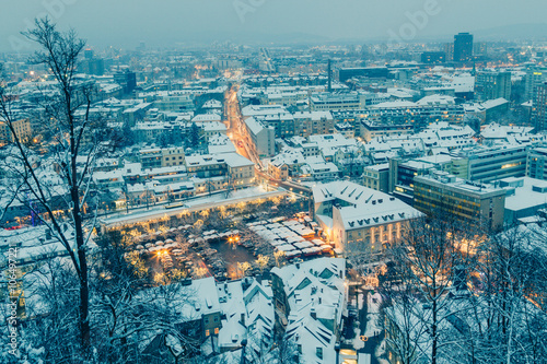 Ljubljana, Slovenia - January 3, 2016. Snowy Ljubljana city twilight view from the hill in the center.