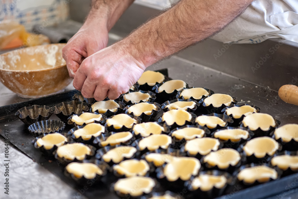 Baker Preparing Pastry for Small Tarts in Bakery Baker Preparing Pastry for Small Tarts in Bakery