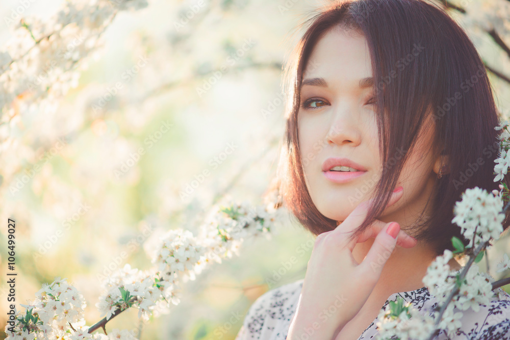 Cherry blossoms. Spring beauty girl outdoors. Blooming trees. Romantic young woman portrait. Sakura Cherry blossoms. Spring beauty girl outdoors. Blooming trees. Romantic young woman portrait. Sakura