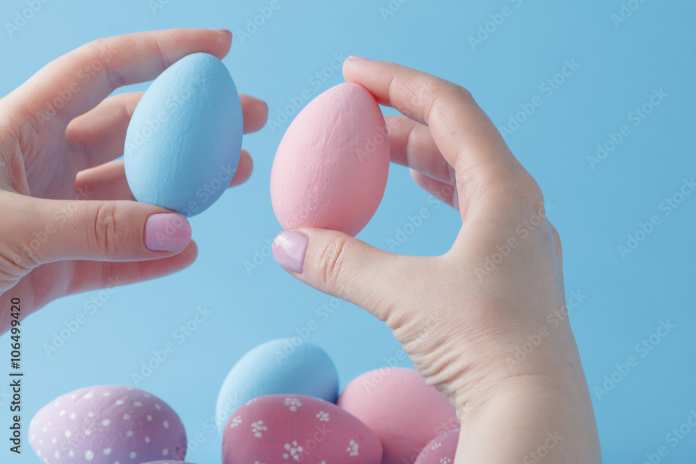 close up of woman hands holding colored easter eggs