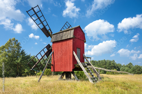 Red windmill, yellow field and blue sky on Baltic Sea island Oland, Sweden photo
